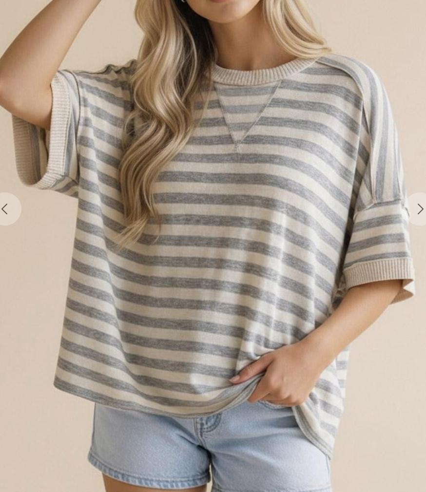 Person wearing a striped shirt and denim shorts on a beige background